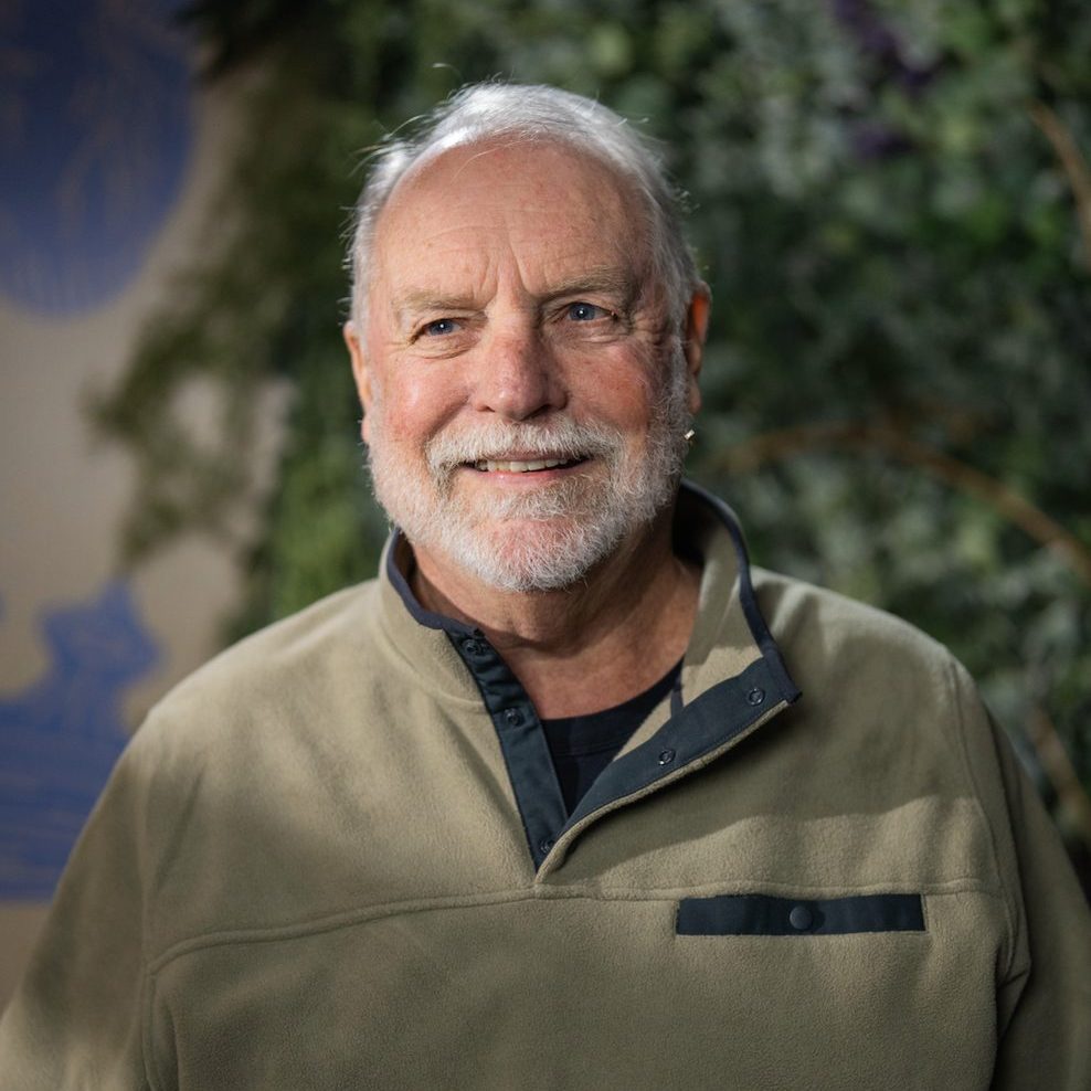 Older man smiling at camera.